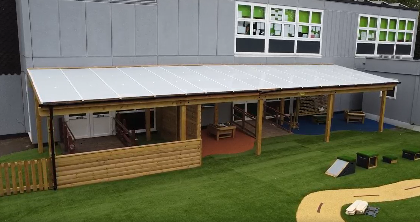 A freestanding timber canopy that has been installed beside the school building.