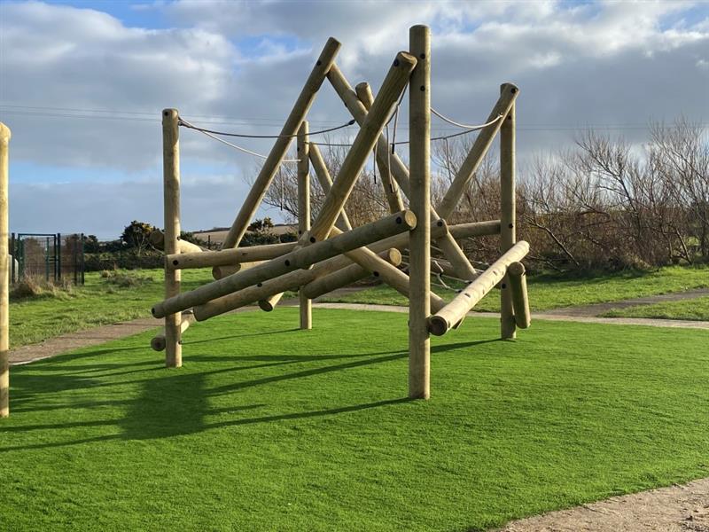 a tryfan climber made of timber sitting on the green artificial grass surfacing