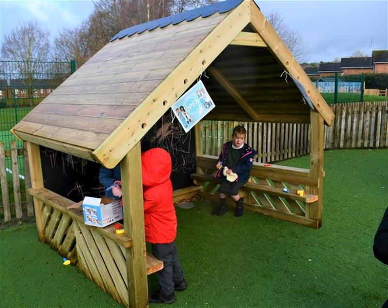 two children play together inside the giant playhouse