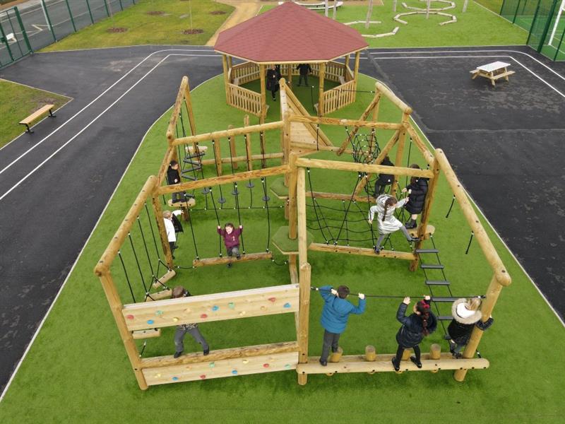 a birdseye view of the roby prk main play zone with a gazebo and a grizedale circuit on artificial grass
