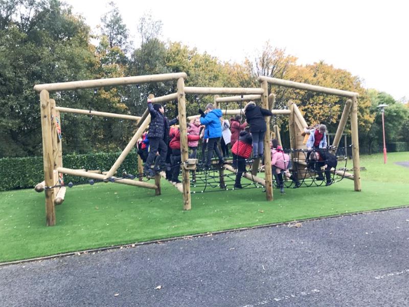 Children climbing on a school playground climbing frame