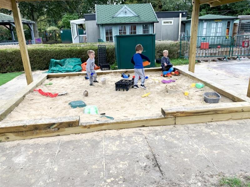 Toddlers playing in a sand pit