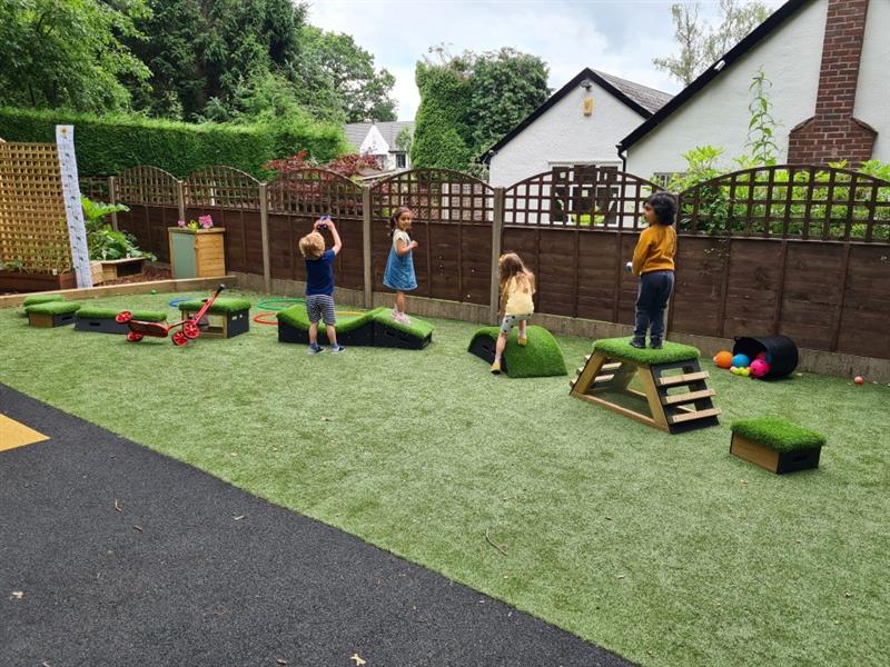 children crossing the get set, go! blocks on the artificial grass surfacing 