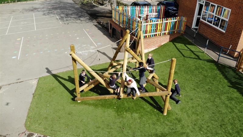 a birdseye view of the bowfell climber being used by children with green artificial grass playturf below for padding