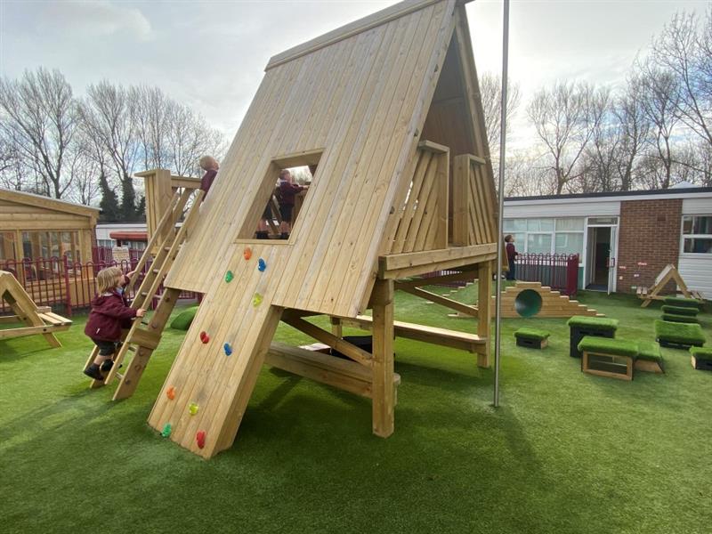 the tree top learning den sits on top of the artificial grass surfacing