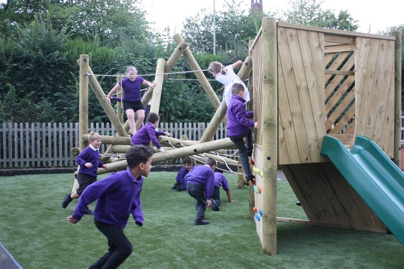 children in purple school uniform climbing on the bowfell climber