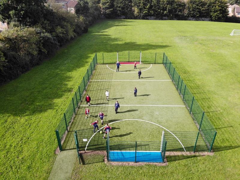 children play a game of football on the MUGA  