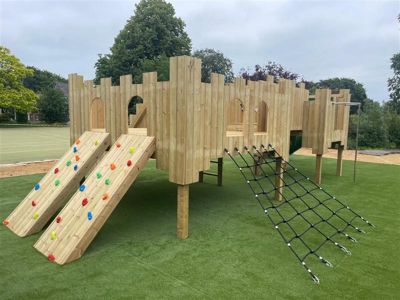 the langley play castle completed standing on the green artificial grass playturf
