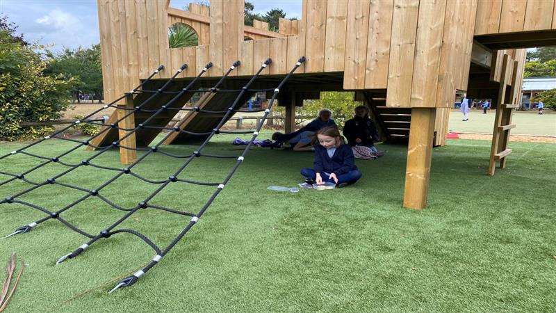 a child sits underneath the langley play castle 