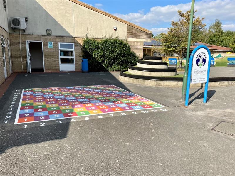 A numbered table thermoplastic design outside the schools main entrance