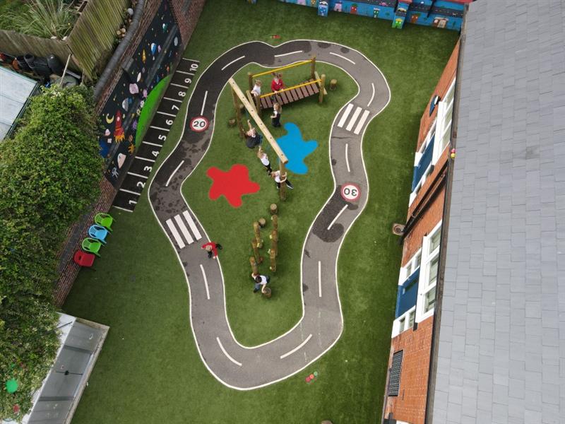 a birdseye view of the green artificial grass playturf and the thermoplastic roadway with saferturf splashes and active play provisions