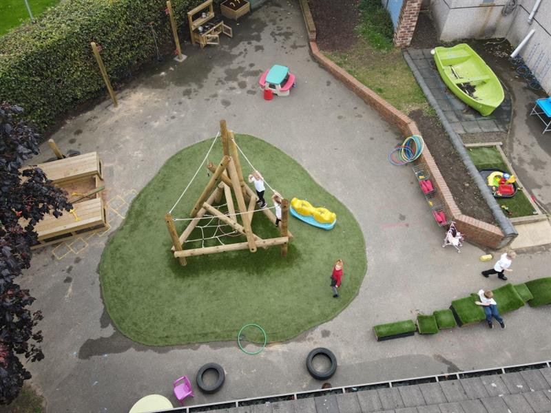 children play on the arter fell climber and the get set go blocks with artificial grass playturf beneath them