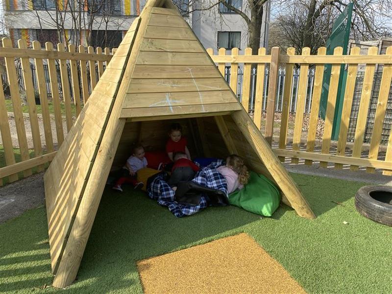3 children sat in the wigwam reading stories to each other