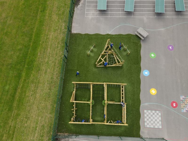 a birdseye view of the playturf artificial grass surfacing with the grizedale and the bowfell climber on it and the playground markings next to it
