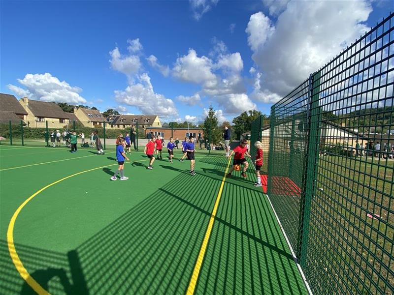 A class of children running on the muga at their primary school