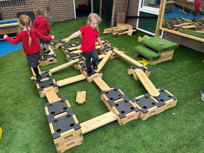 a child practises balancing on the play builder engineer set