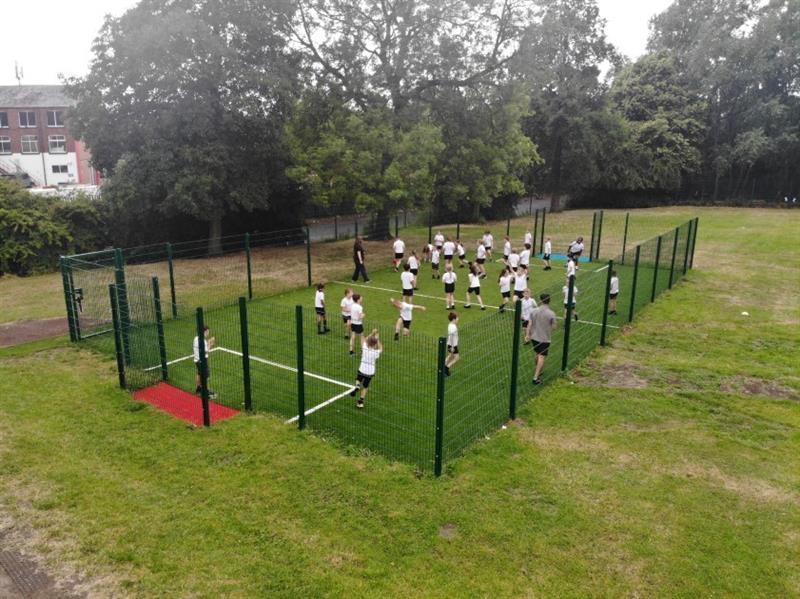 a birdseye view of the muga showing the children playing football 