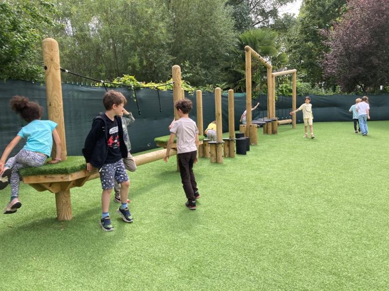 children play on the active play trail