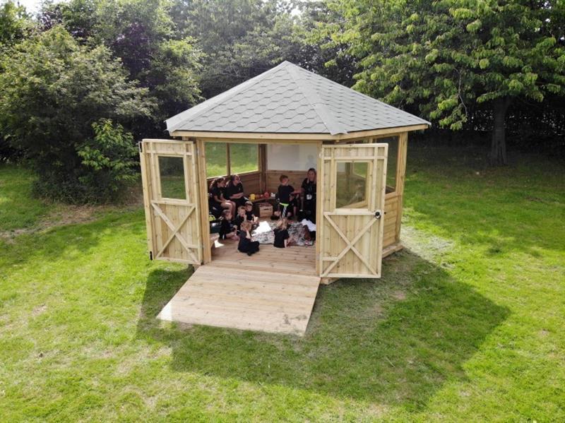 a view into the outdoor classroom being used by the pupils