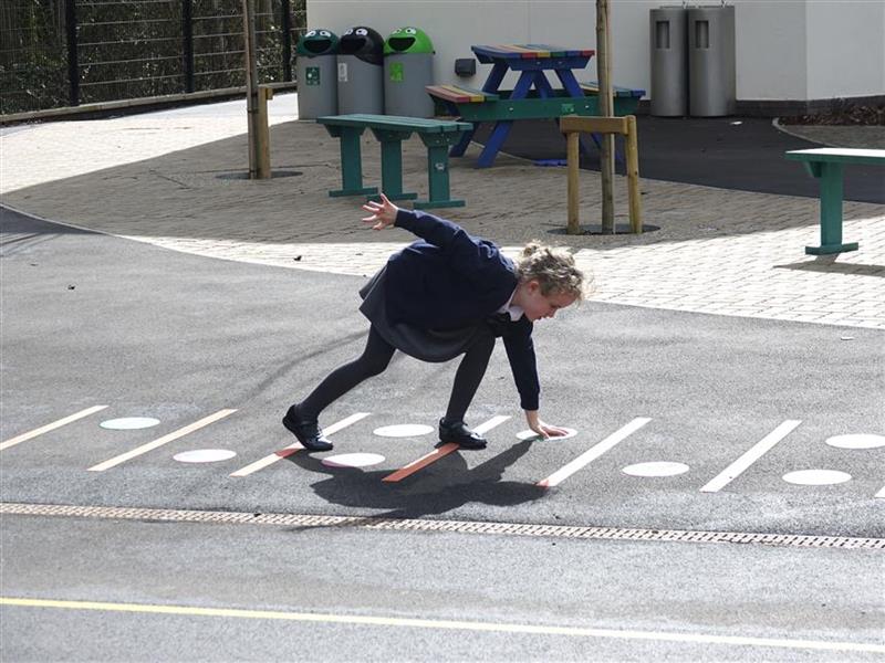 children playing on the playground markings in their play space