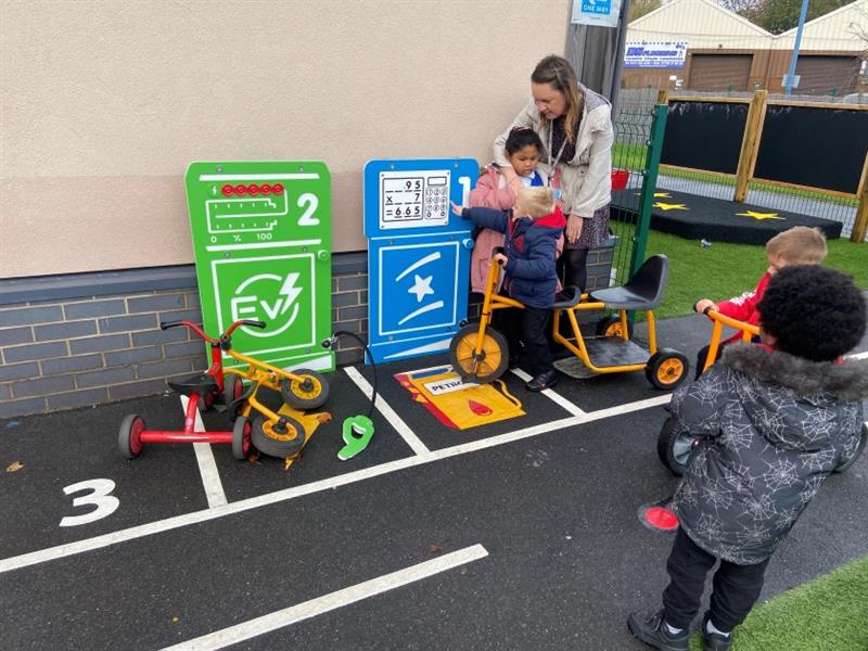 children park in electric and petrol bays on their wetpour roadway