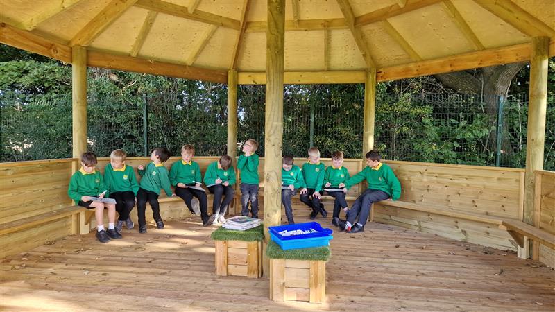 Inside the outdoor gazebo in a primary school setting