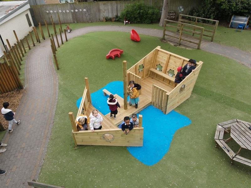 a birdseye view of the play ship on artificial grass and saferturf blue surfacing