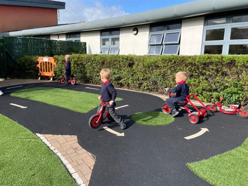 a shot of the wetpour roadway with children scooting around it