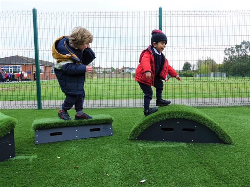2 young boys climbing on the movable blocks 