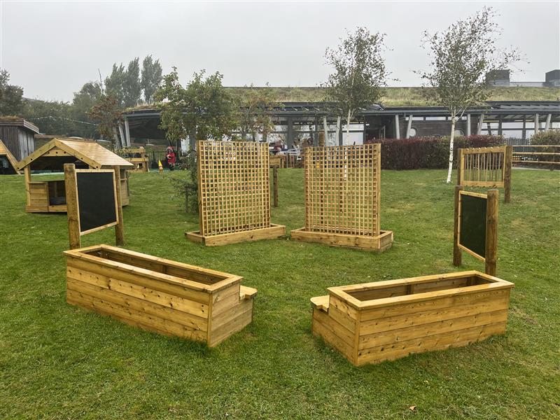 A side view of the weaving panels and giant chalk board in a primary school playground setting