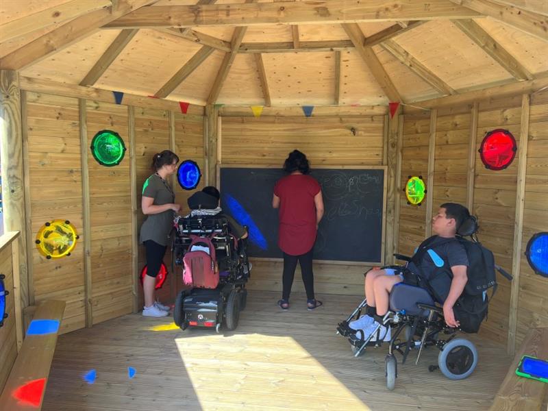 inside the sensory gazebo with lots of colour and bubble windows for pupils with sensory issues to explore
