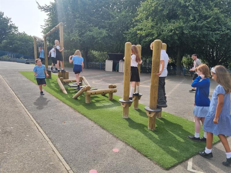children queue to try the trim trail