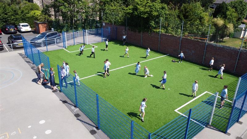 a birdseye view of the MUGA with children playing football on it