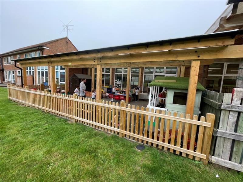 a shot of the outdoor timber canopy for the pupils at the royal kent school