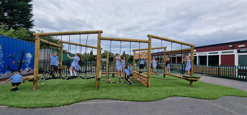 children run around on the timber climber and play with their friends