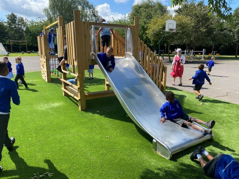 children slide down a slide