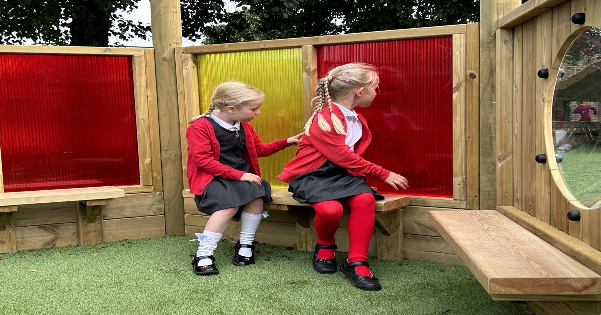 two school children playing in an imagination station