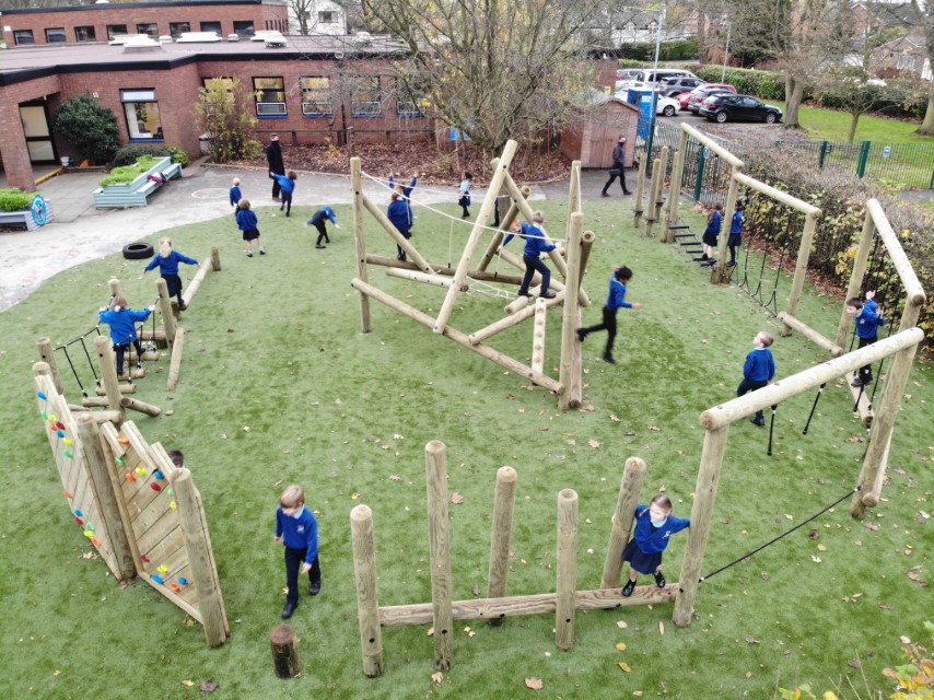 Children playing on a pentagon play forest trim trail