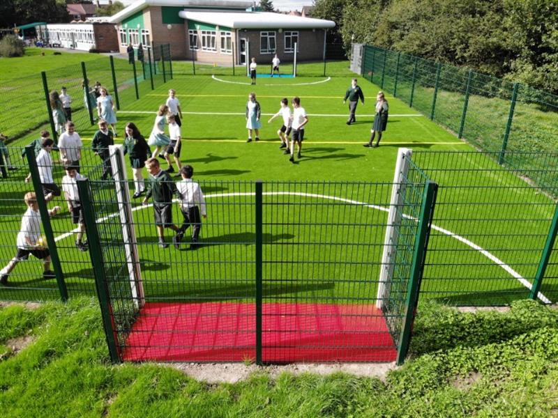 Children enjoying sport on a Pentagon Play muga pitch