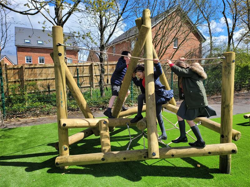 three children playing on our pincale climber