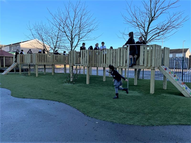 Children playing on a huge playground treehouse