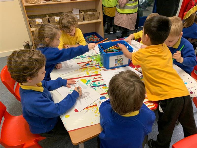 children gather around the table and colour using colouring pencils in a tub on the table