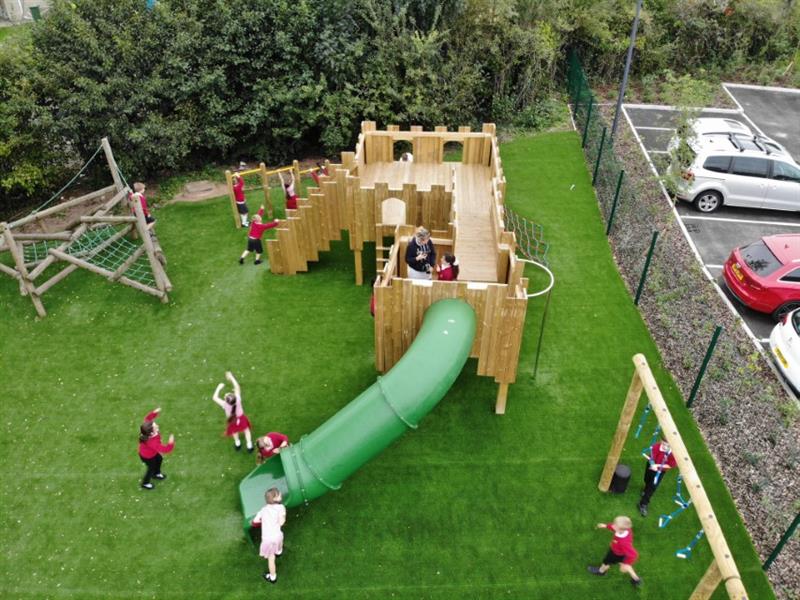 children run around on an active play castle