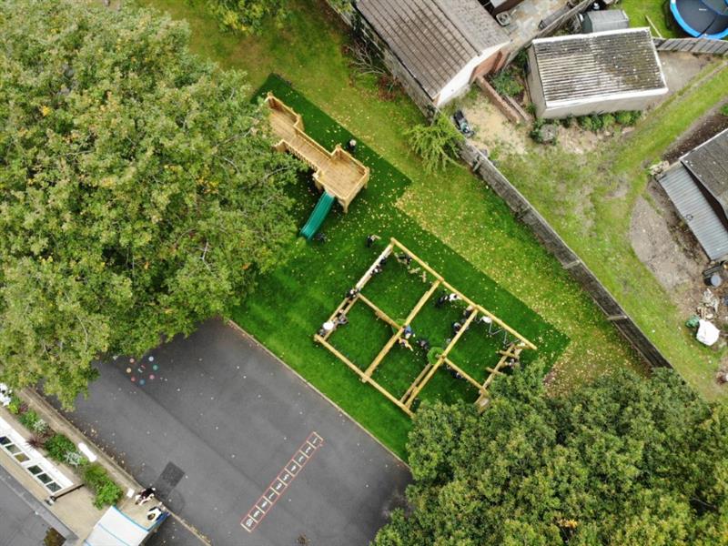A birds eye view of a forest trim trail and play tower