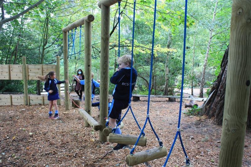 Children playing on a school playground trim trail