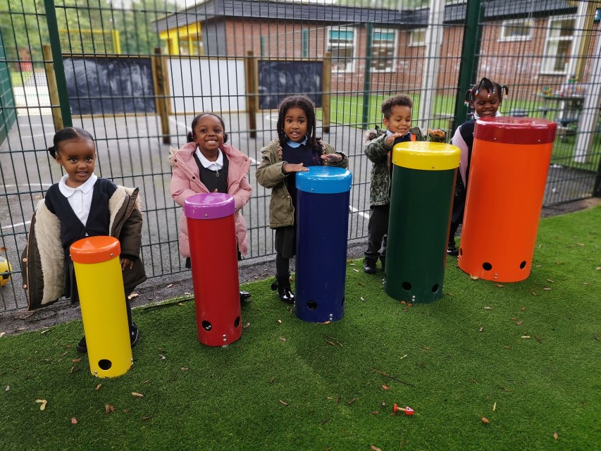 Group of 5 children are playing with African Drums, as they make a variety of sounds.