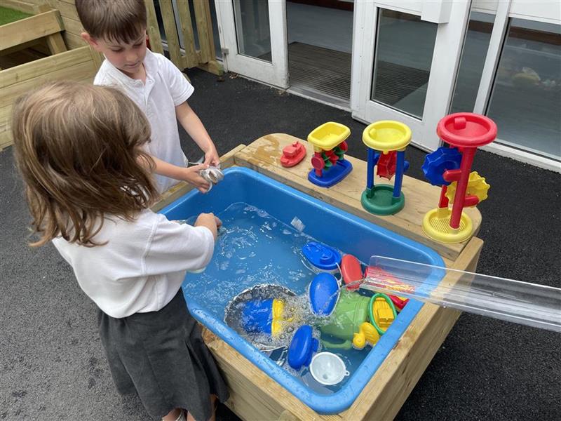 children playing in the water box