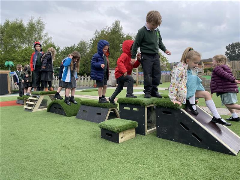 A class of children playing on the get set go blocks in their play area