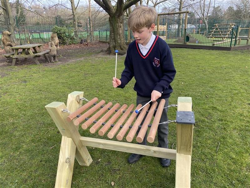 one young boy playing on the musical marimba
