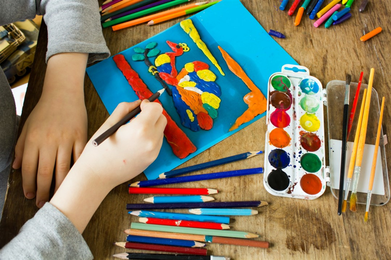 a child creates a 3D painting image using craft supplies